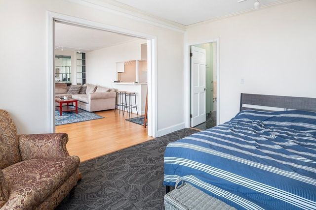a bedroom with furniture and a wooden floor