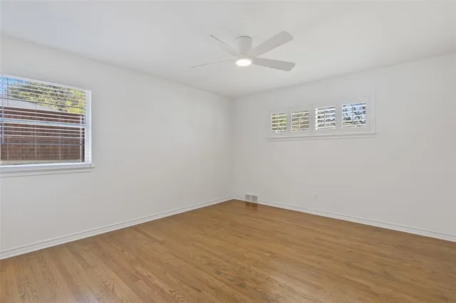a view of a room with wooden floor and white walls