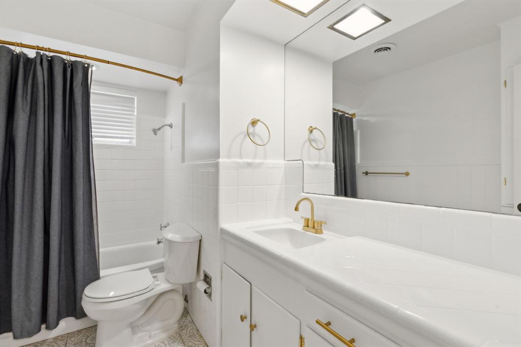 10510 Gooding Drive Dallas, TX 75229 - Photo 13 of 14 a bathroom with a sink a toilet and shower