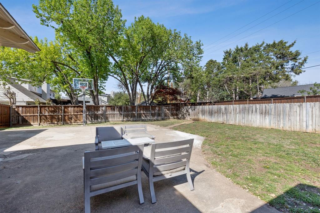 10510 Gooding Drive Dallas, TX 75229 - Photo 14 of 14 a view of a patio with table and chairs with wooden fence and plants