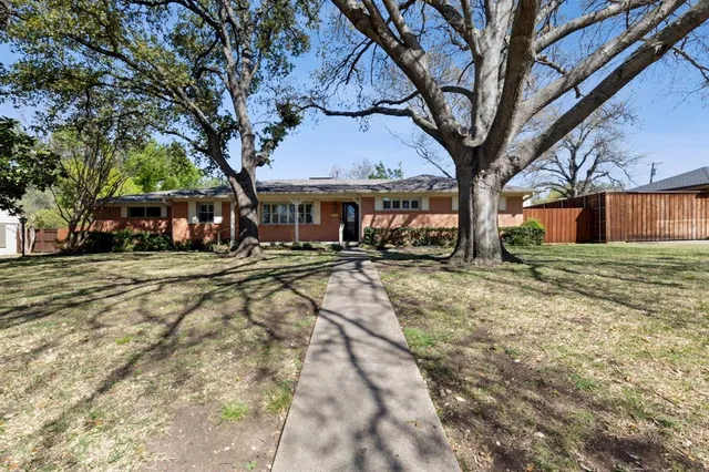a view of swimming pool with outdoor seating and house in the background