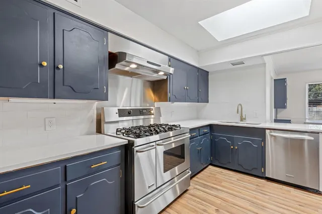 a kitchen with a stove and a sink