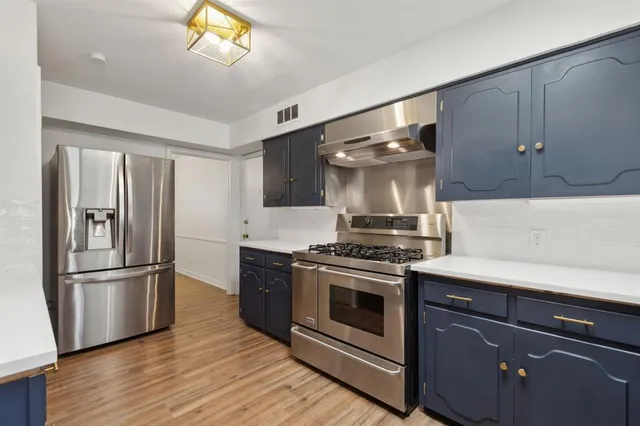 a kitchen with a stove refrigerator and microwave