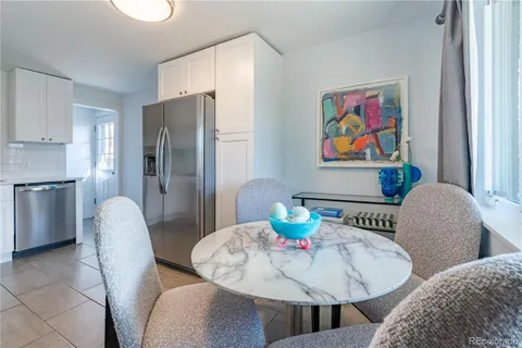 a view of a dining room with furniture a rug and wooden floor