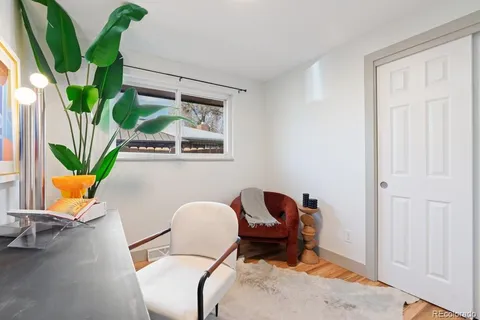 an empty room with a window and wooden floor
