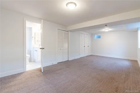 a view of a chair and table in backyard of the house