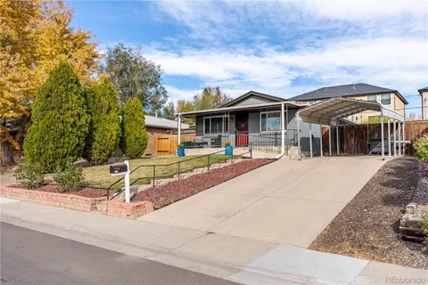 a view of a porch with chairs and floor to ceiling window