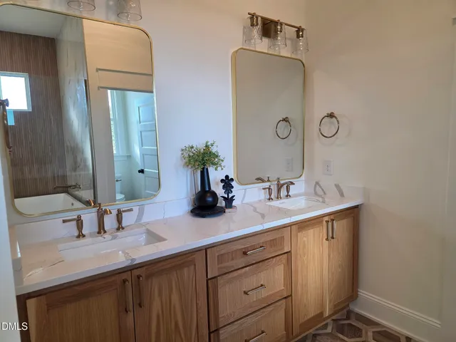 a view of a house with two chairs and a barbeque