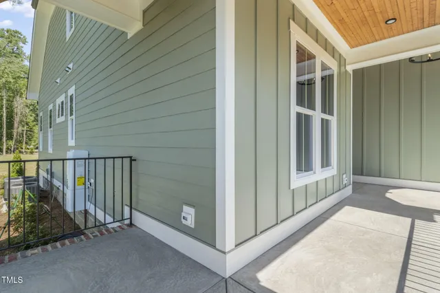 a view of a balcony with wooden floor and fence