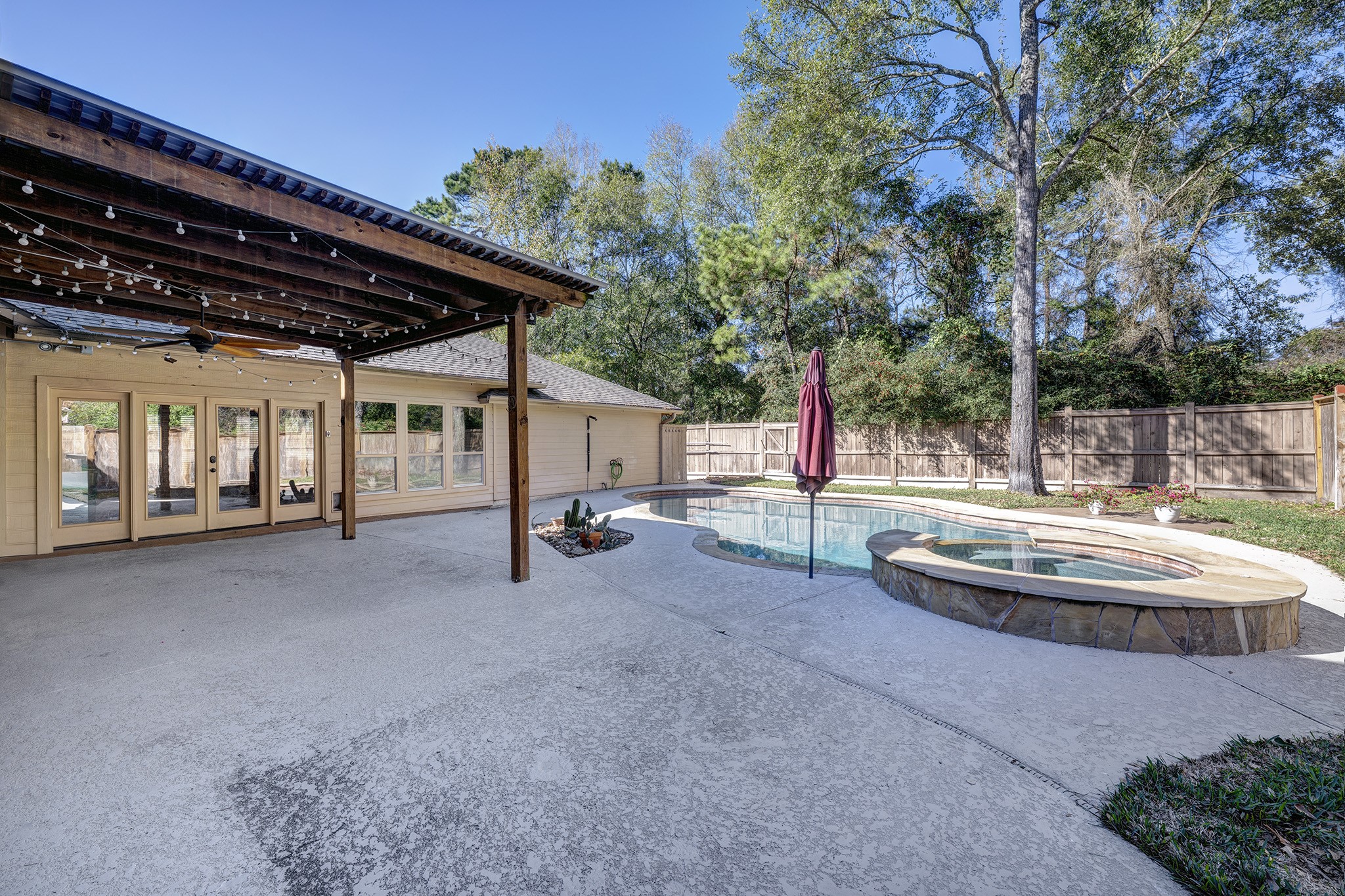 2511 Bridgestone Park Lane Spring, TX 77386 - Photo 22 of 25 Additional view shows the extended garage and covered patio. French doors open to the first 3-car bay which is perfect as a party room!