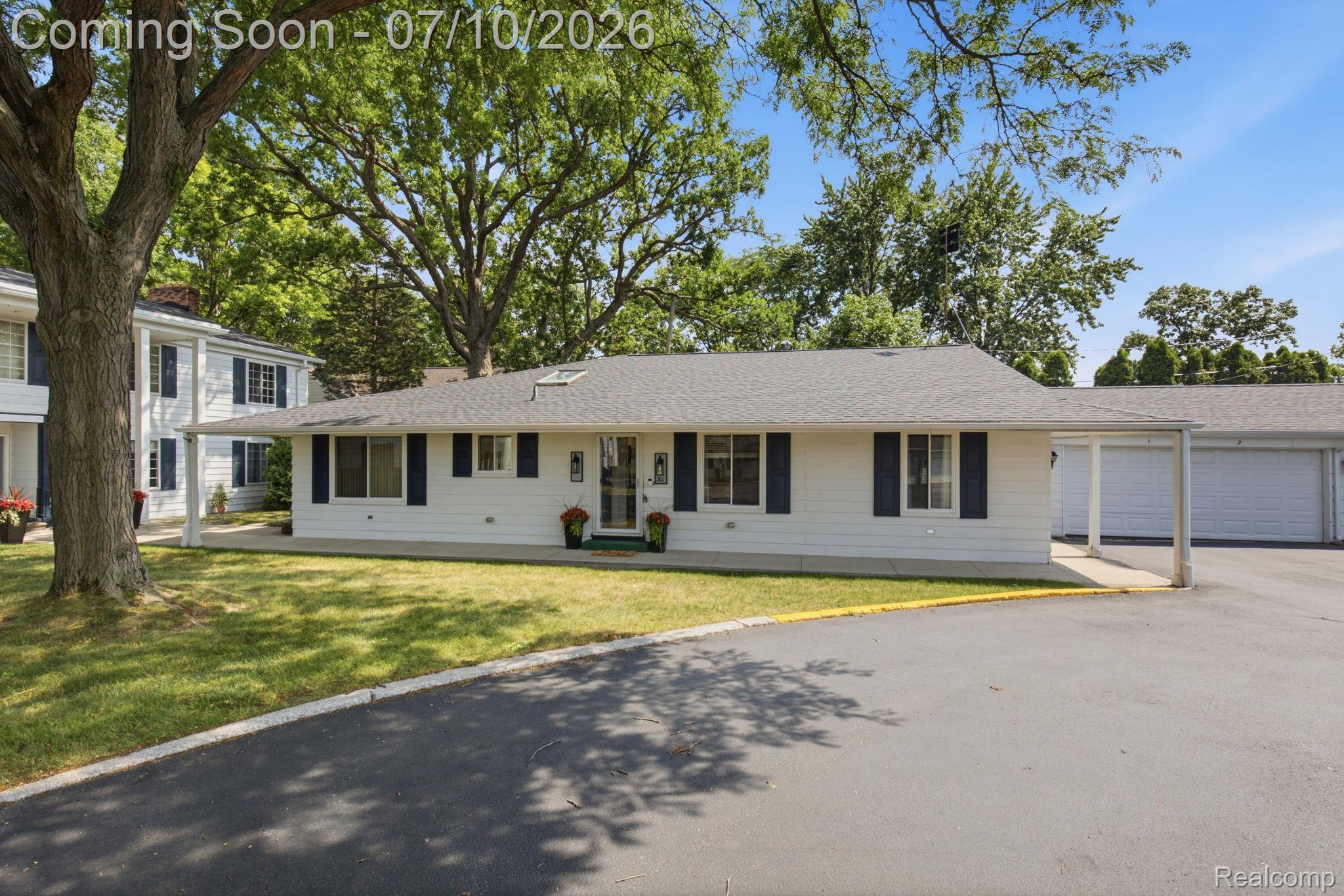 1501 River Road, Unit 301 St. Clair, MI 48079 - Photo 2 of 32 Ranch-style residence featuring a white exterior, dark window shutters, and a gray shingle roof
