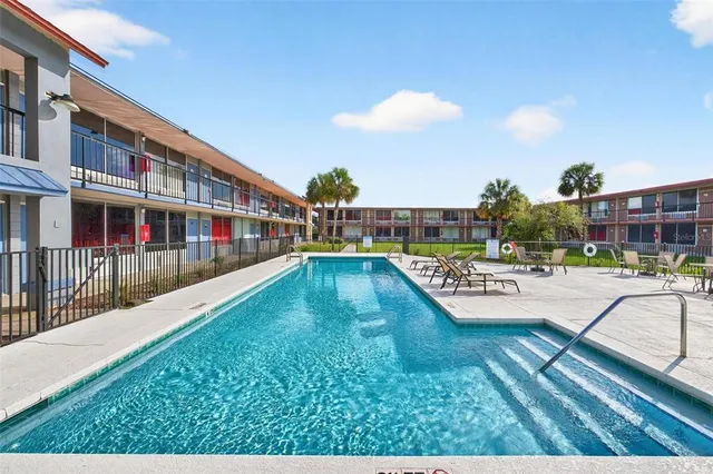 a view of a swimming pool with a lounge chairs