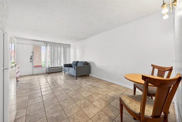 a kitchen with a white cabinets and a refrigerator