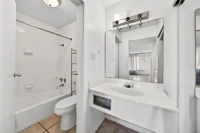 a bathroom with a sink vanity granite and a mirror