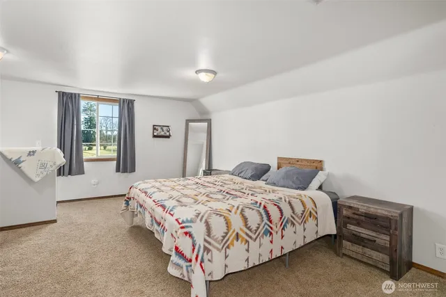 a bedroom with a bed and window