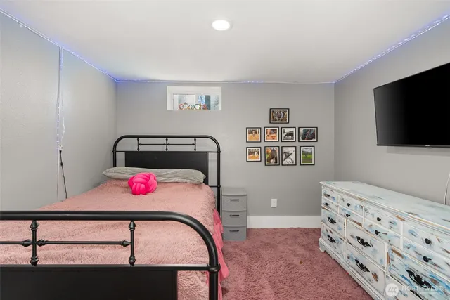 a bedroom with furniture and a flat screen tv