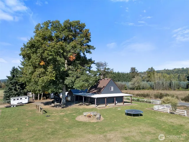 an aerial view of a house with swimming pool garden and patio
