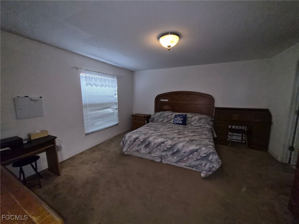 2604 Old Burnt Store Road North Cape Coral, FL 33993 - Photo 5 of 13 a bedroom with a bed and a window