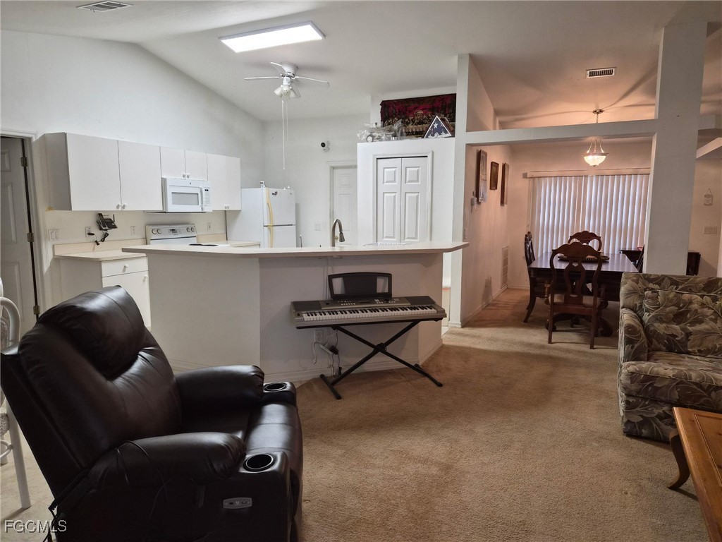 2604 Old Burnt Store Road North Cape Coral, FL 33993 - Photo 9 of 13 a living room with furniture a rug and kitchen view
