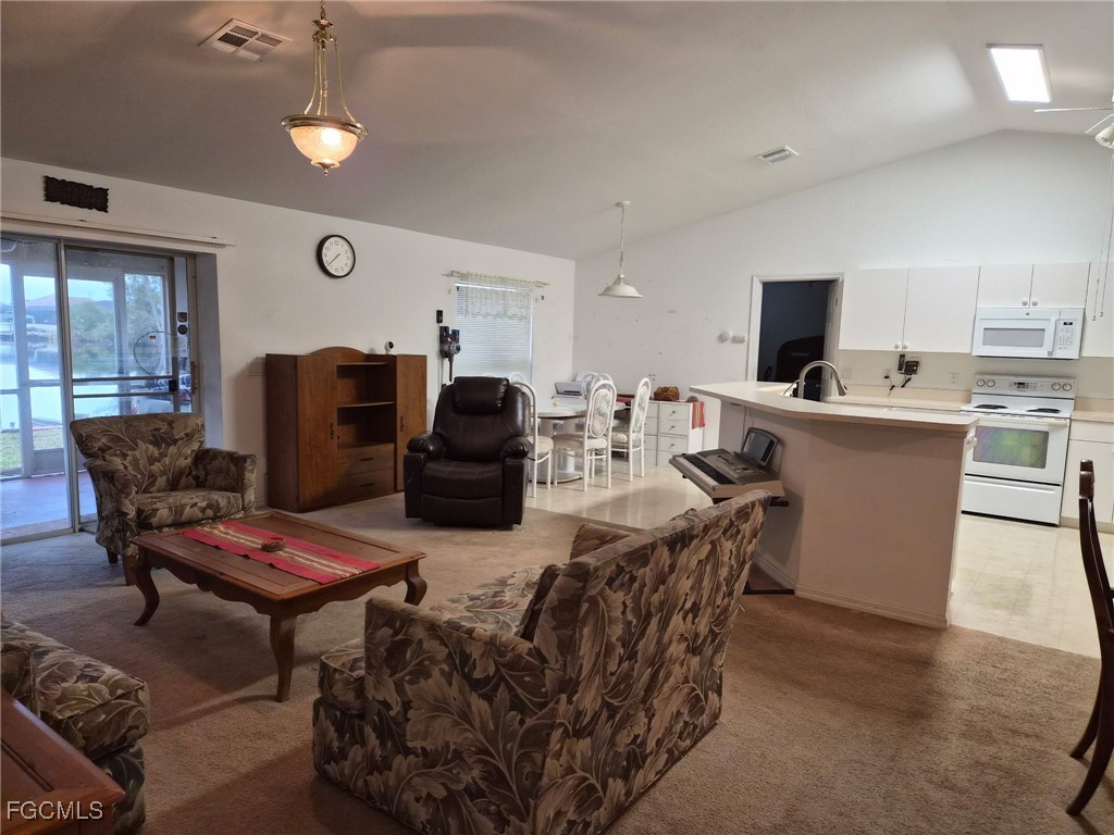 2604 Old Burnt Store Road North Cape Coral, FL 33993 - Photo 10 of 13 a living room with furniture a flat screen tv and a dining table