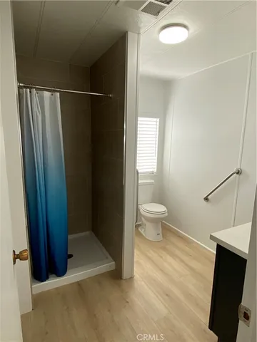 a bathroom with a toilet and a shower