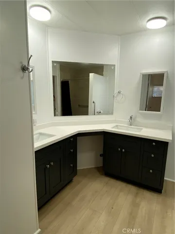 a bathroom with a double vanity sink and mirror
