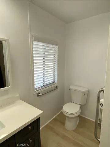 a bathroom with a toilet a sink and a window