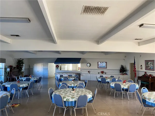a living room with lots of furniture and view of kitchen