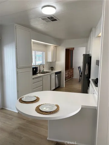 a kitchen with a table and chairs in it