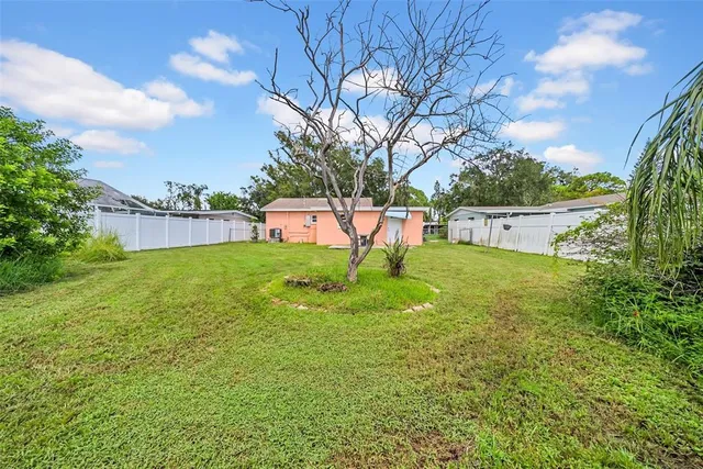 a view of yard with swimming pool and green space