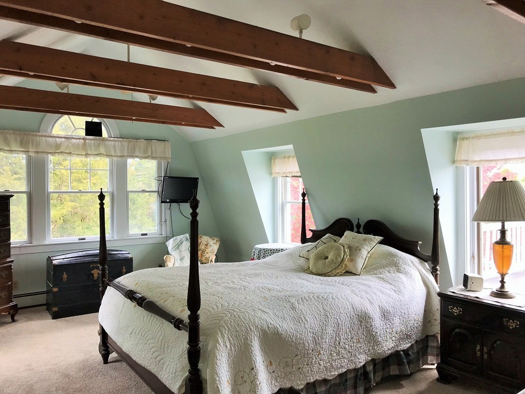 17 Clinton Street Hopkinton, MA 01748 - Photo 17 of 27 a bedroom with a bed and wooden floor