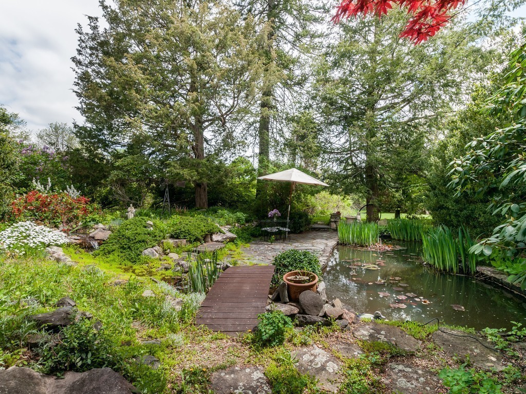 17 Clinton Street Hopkinton, MA 01748 - Photo 23 of 27 a view of a backyard with plants and a garden