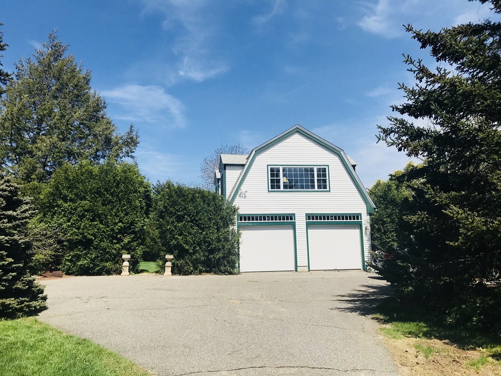17 Clinton Street Hopkinton, MA 01748 - Photo 4 of 27 a front view of a house with a yard and garage