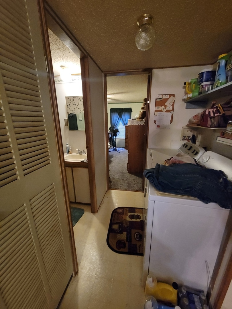 47 Partridge Lane, Unit 47PART Beecher, IL 60401 - Photo 16 of 16 a hallway with storage and utility