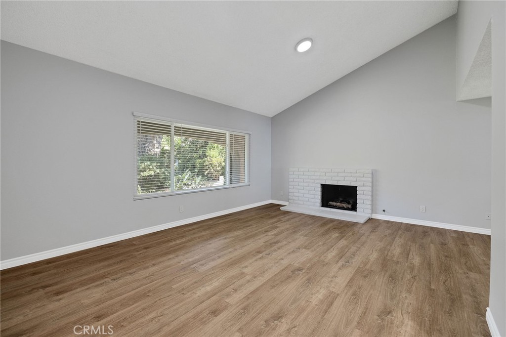 3418 Seaglen Drive Rancho Palos Verdes, CA 90275 - Photo 19 of 42 a view of empty room with wooden floor and fireplace