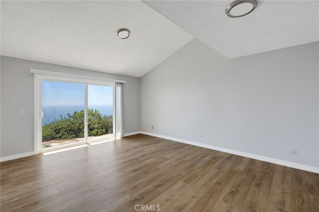 3418 Seaglen Drive Rancho Palos Verdes, CA 90275 - Photo 23 of 42 a view of an empty room with wooden floor and a window