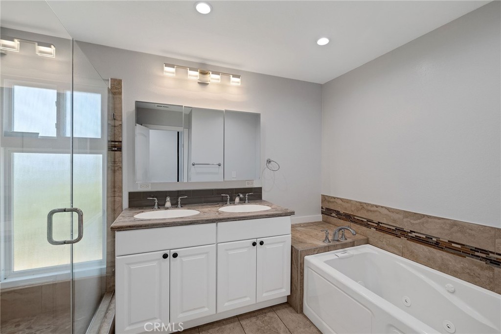 3418 Seaglen Drive Rancho Palos Verdes, CA 90275 - Photo 27 of 42 a bathroom with a granite countertop sink and mirror with bathtub