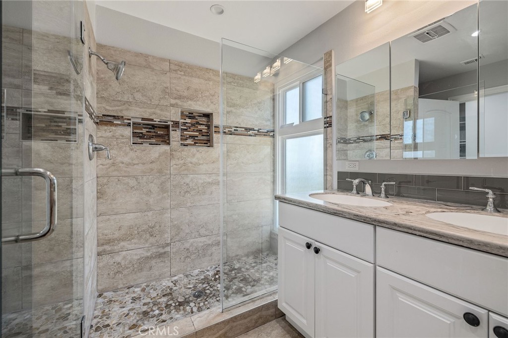 3418 Seaglen Drive Rancho Palos Verdes, CA 90275 - Photo 28 of 42 a bathroom with a granite countertop sink a mirror and shower