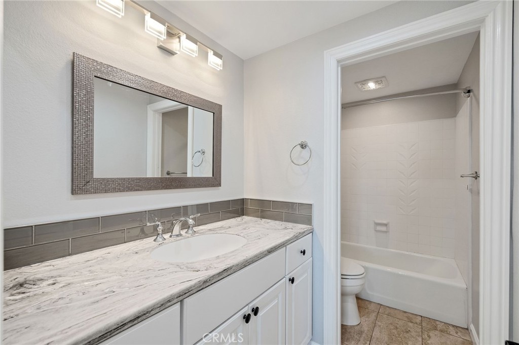 3418 Seaglen Drive Rancho Palos Verdes, CA 90275 - Photo 29 of 42 a bathroom with a granite countertop sink mirror and a bathtub