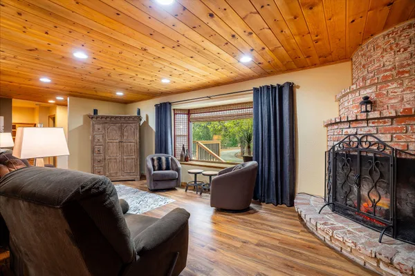 a living room with furniture a fireplace and a flat screen tv