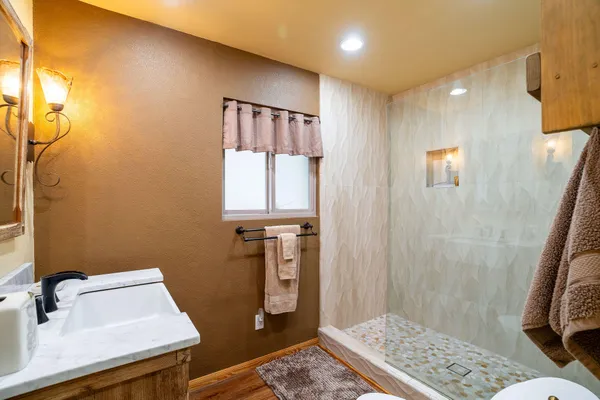 a bathroom with a sink a toilet and shower