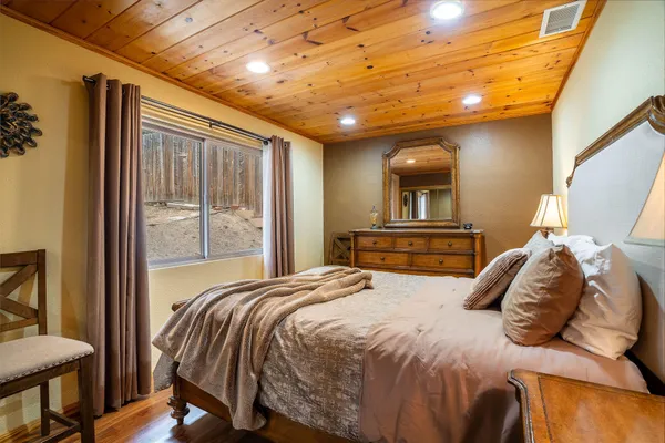 a bedroom with a large bed and a window