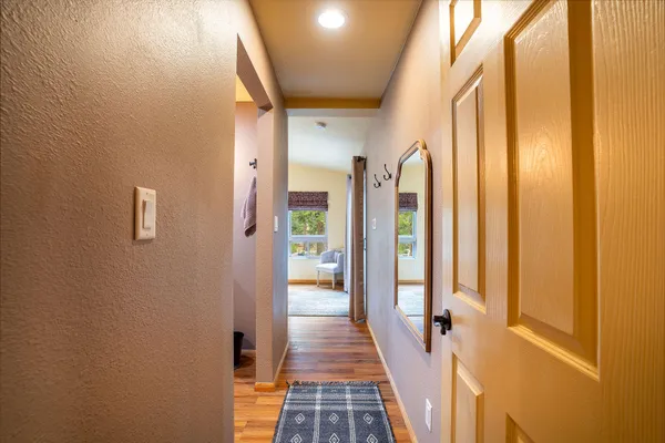 a bathroom with a granite countertop sink a toilet a mirror and shower