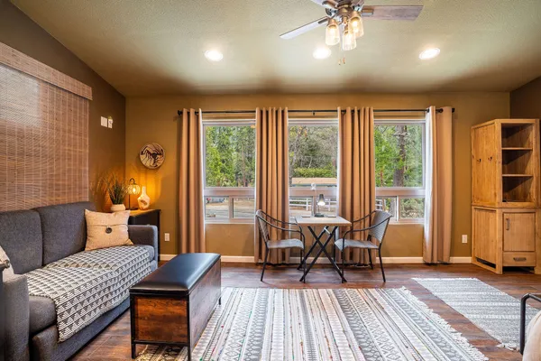 a bedroom with furniture and a large window