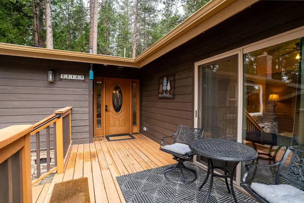 a backyard of a house with barbeque oven table and chairs