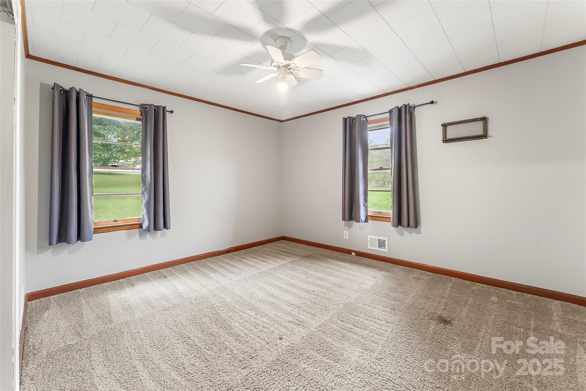 2777 Pax Hill Road Morganton, NC 28655 - Photo 11 of 33 an empty room with windows and ceiling fan