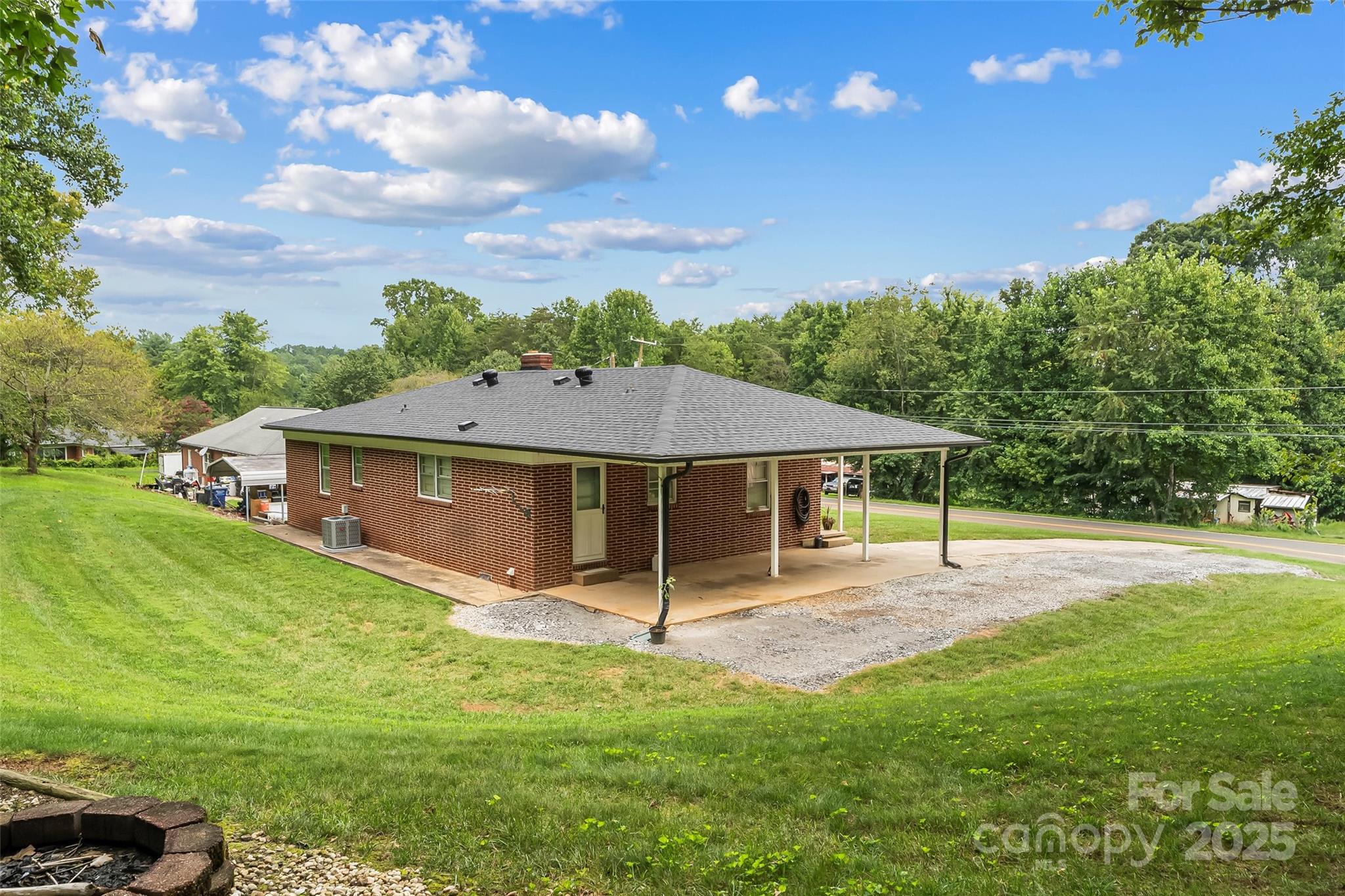 2777 Pax Hill Road Morganton, NC 28655 - Photo 21 of 33 a view of a house with yard and a garden
