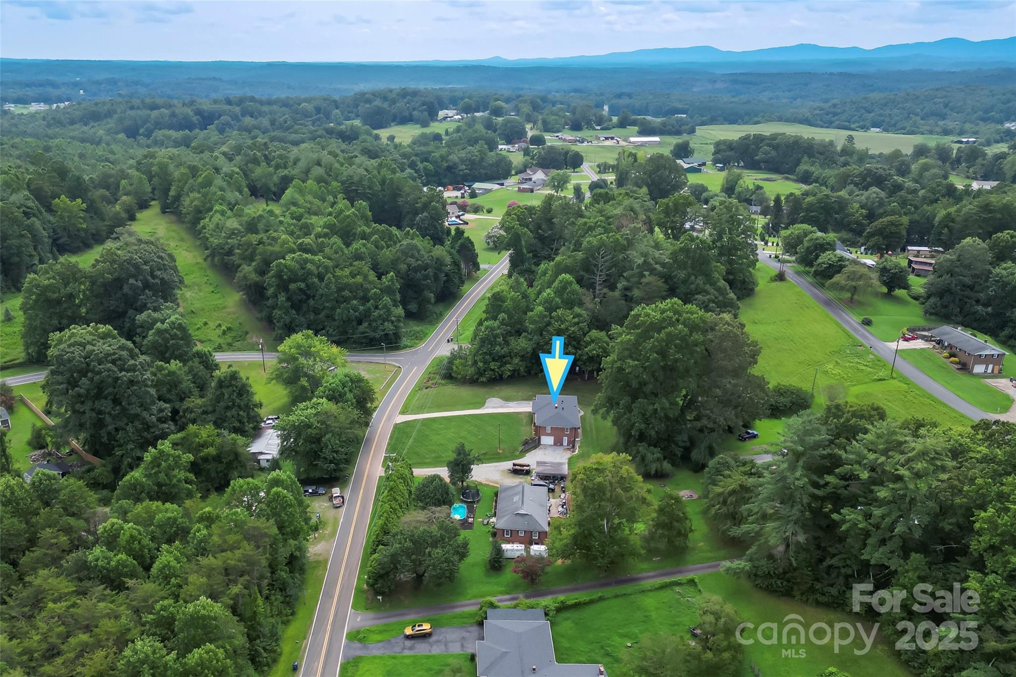 2777 Pax Hill Road Morganton, NC 28655 - Photo 30 of 33 an aerial view of green landscape with trees houses and mountain view