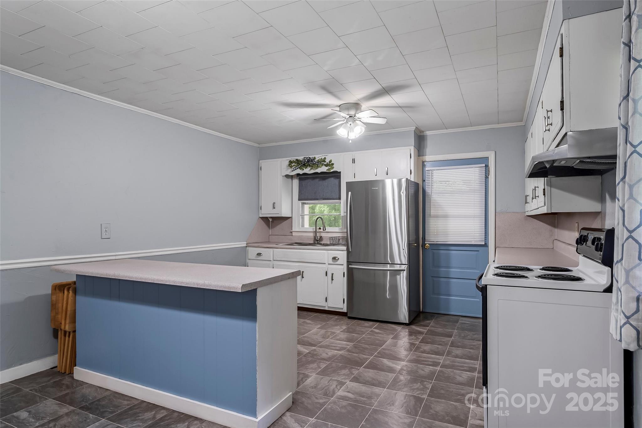 2777 Pax Hill Road Morganton, NC 28655 - Photo 7 of 33 a kitchen with a refrigerator and a sink
