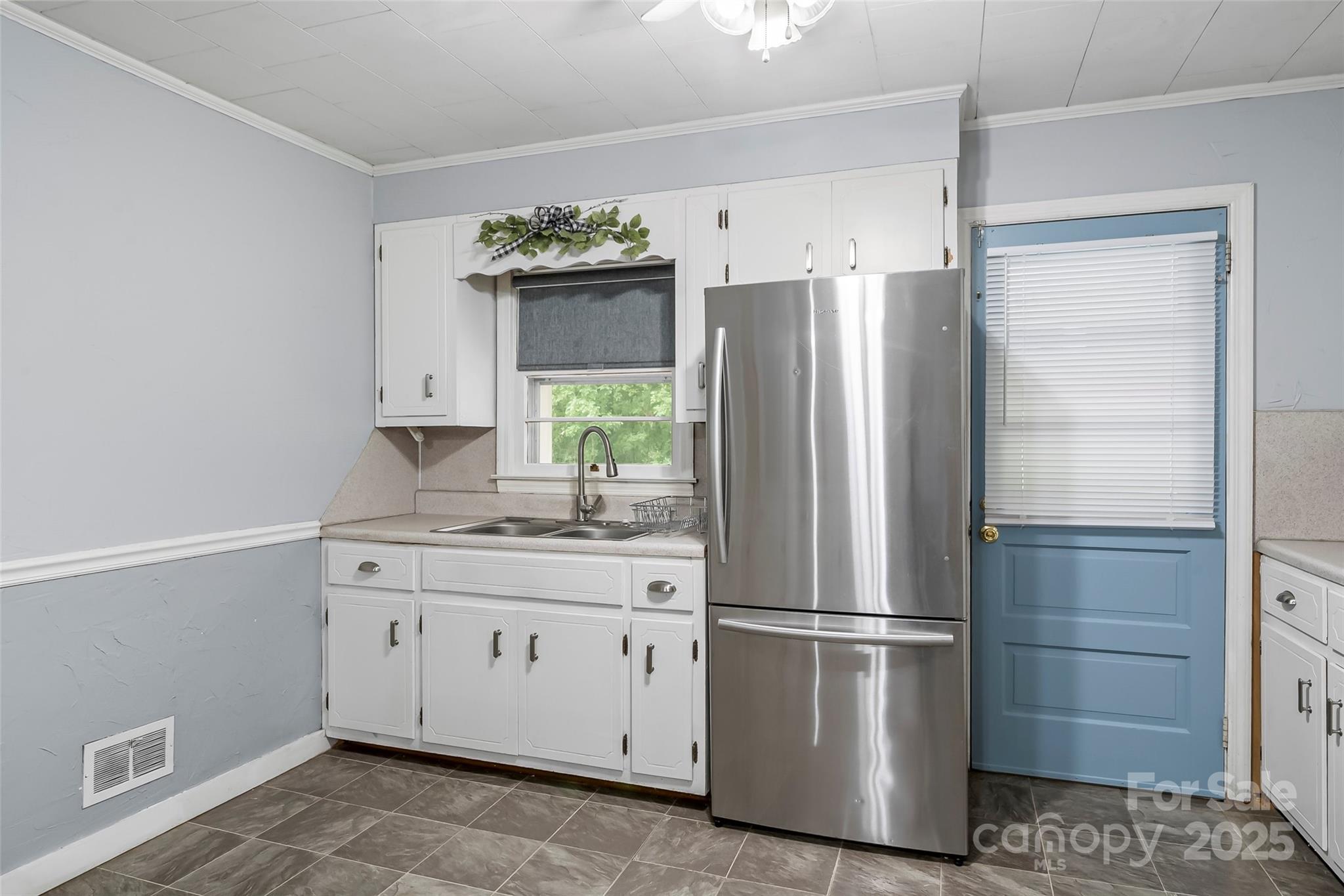 2777 Pax Hill Road Morganton, NC 28655 - Photo 9 of 33 a kitchen with stainless steel appliances a refrigerator sink and cabinets